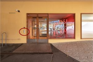 If you arrive with a pre-booked ticket, enter from the Lasipalatsi Square side through this accessible entrance. The door’s opening button is circled. 